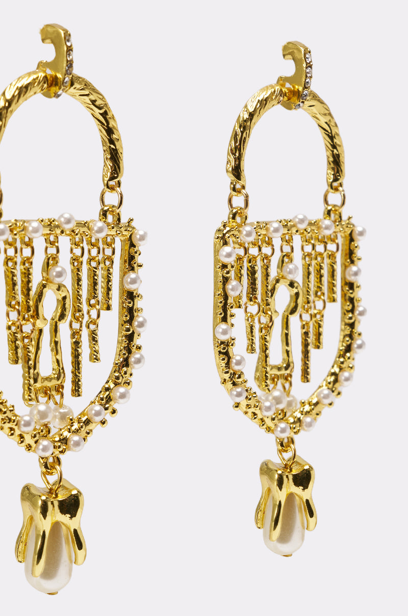 The UNLOCK ME EARRING features gold statement chandelier design with small pearl beads, baroque faux pearls, dangling gold fringe, a large pearl drop, textured finish, and an elegant arched top for a bold look. 3
