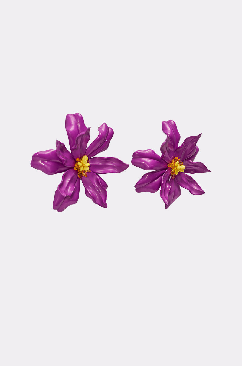 Two IN THE GARDEN EARRING statement pieces in bold metallic purple with yellow centers are displayed on a plain light gray background. 2