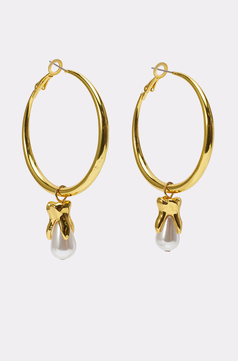 GENUINE EARRING: Gold hoops each with a dangling white pearl set in a sculptural charm, shown on a plain white background. 0