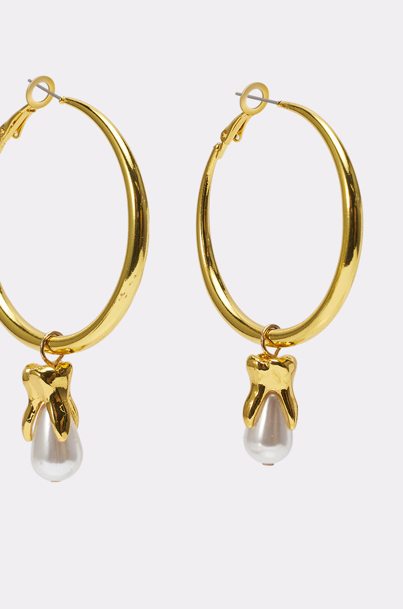 GENUINE EARRING: Sculptural gold hoop earrings with irregular, shiny settings and dangling white pearls, displayed against a plain light background. 3