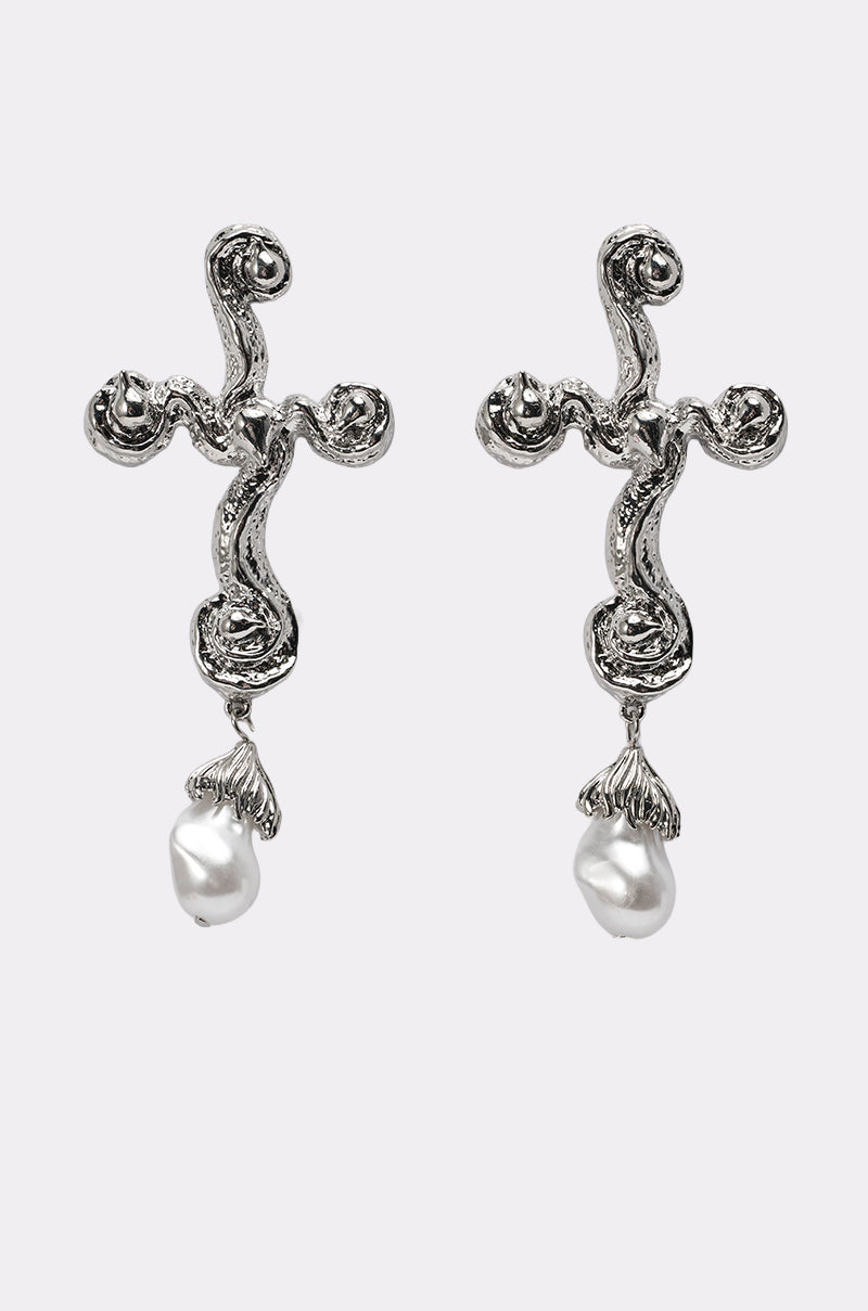 The CROSS ME EARRING features a pair of silver cross earrings with a wavy, textured design, each accented by a single dangling white pearl—ideal statement pieces for any occasion. 0