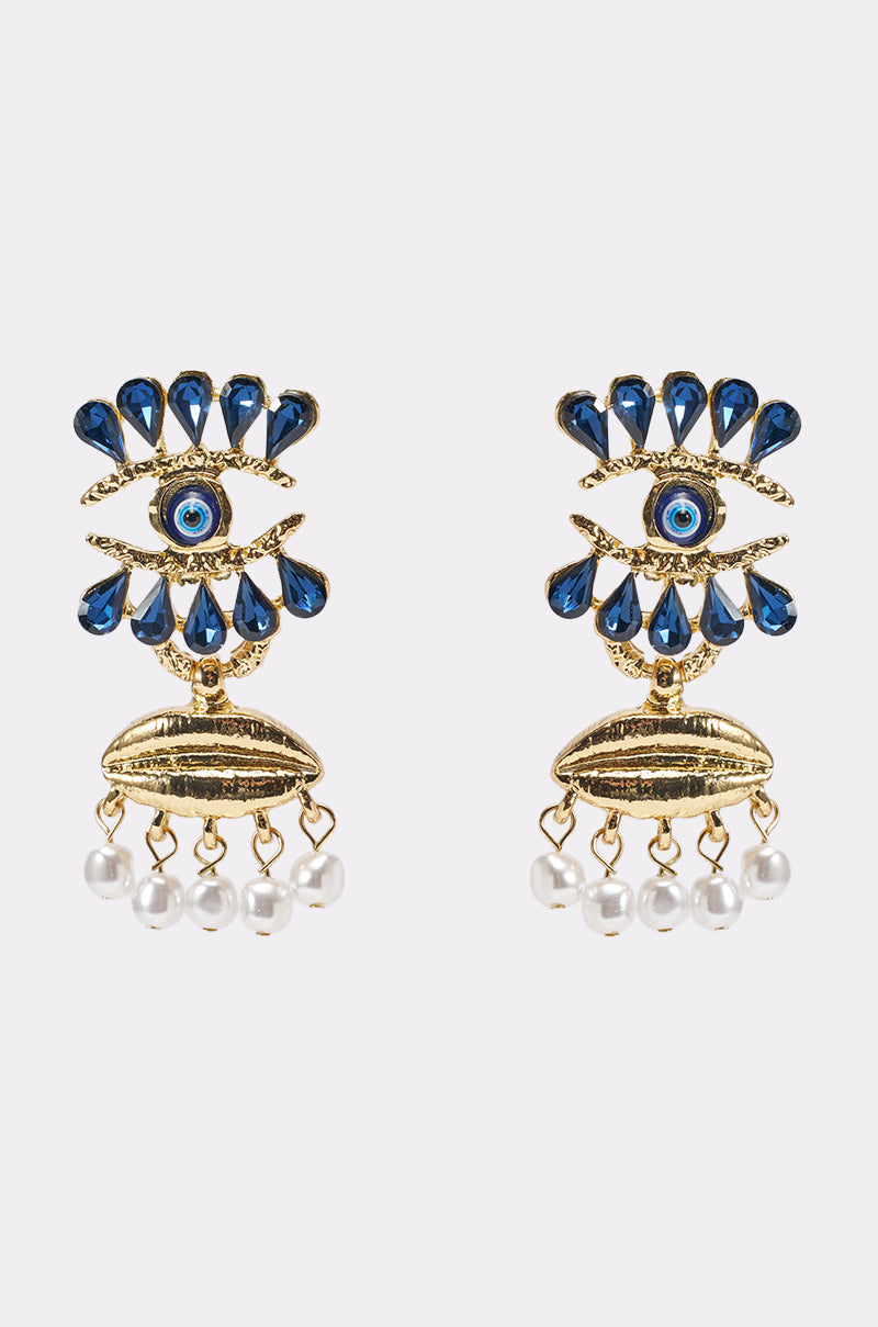 The TWO FACED EARRING features a gold evil eye design with blue and white stones, gold accents, and dangling pearl details—perfect as bold statement festival jewelry. Shown on a plain white background. 0
