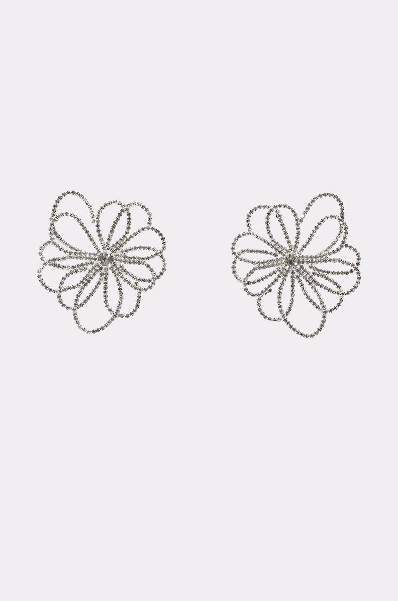 The IM OUTSIDE EARRING features two silver crystal flower earrings with sparkling, overlapping petal strands, creating an elegant, eye-catching accessory displayed on a plain white background. 1