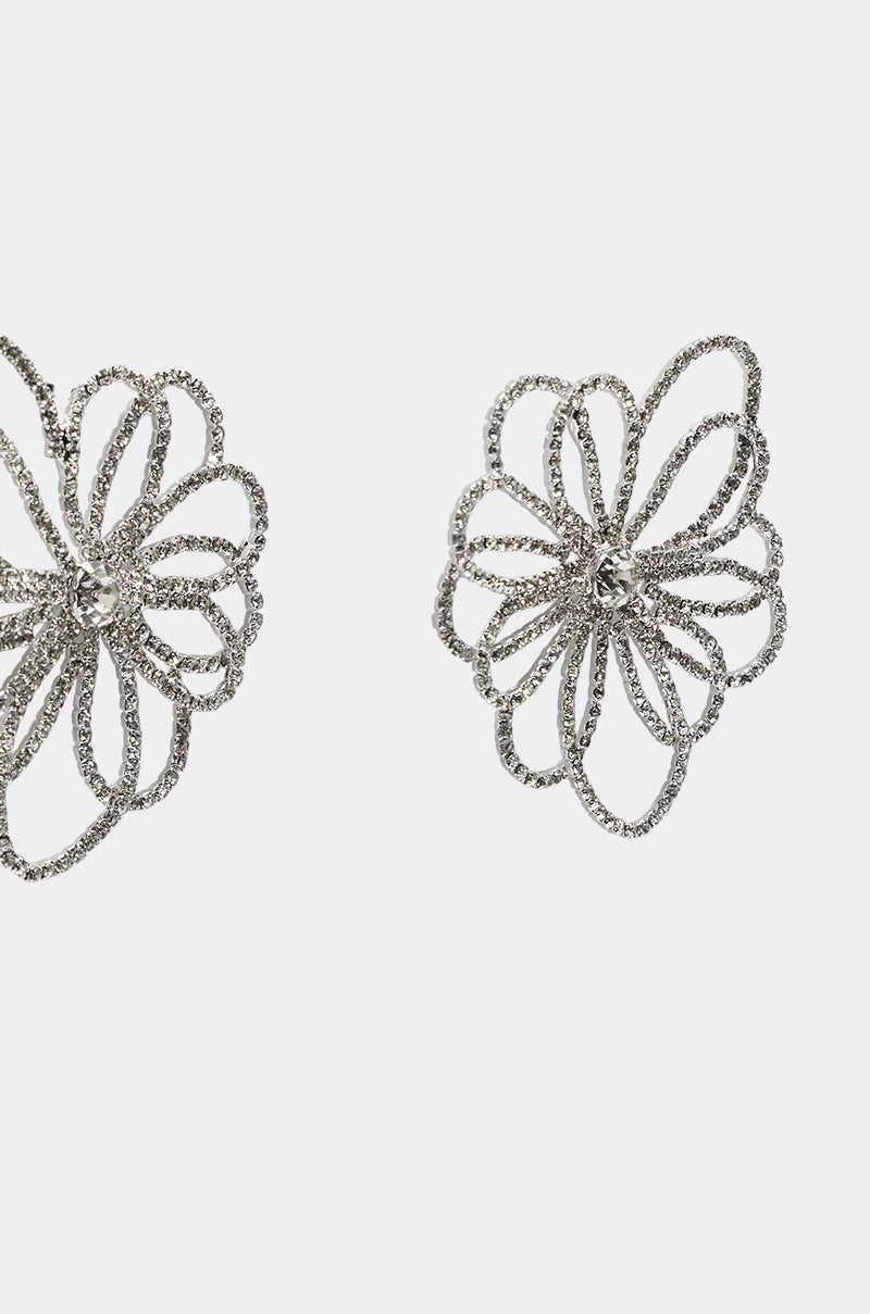 Two IM OUTSIDE EARRING silver statement earrings featuring intricate openwork flower shapes with looping petals, displayed on a plain white background. 4