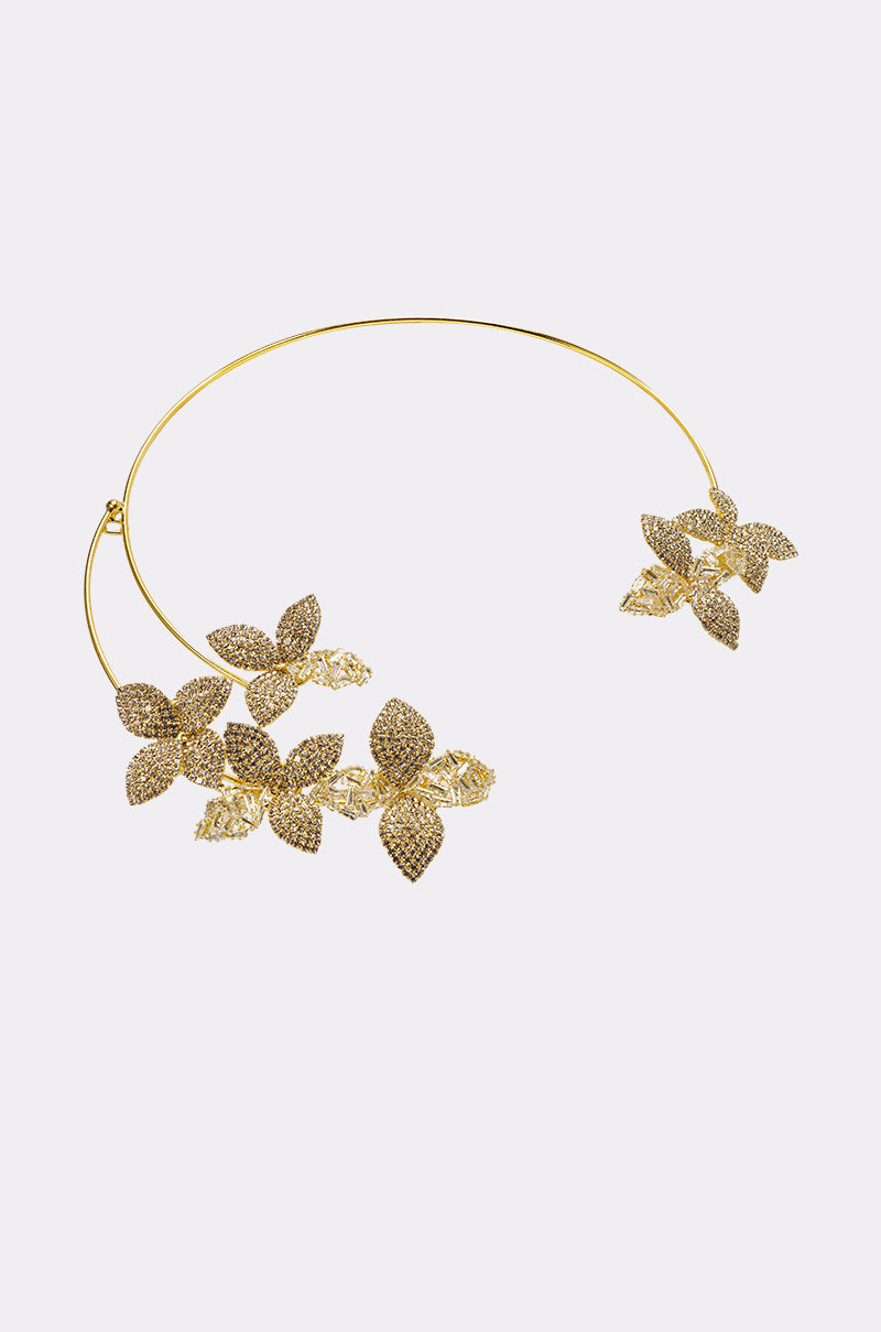 The IN BLOOM NECKLACE is a gold-tone collar necklace with intricate, asymmetrical floral designs and sparkling rhinestones—an elegant accessory for any occasion. 0