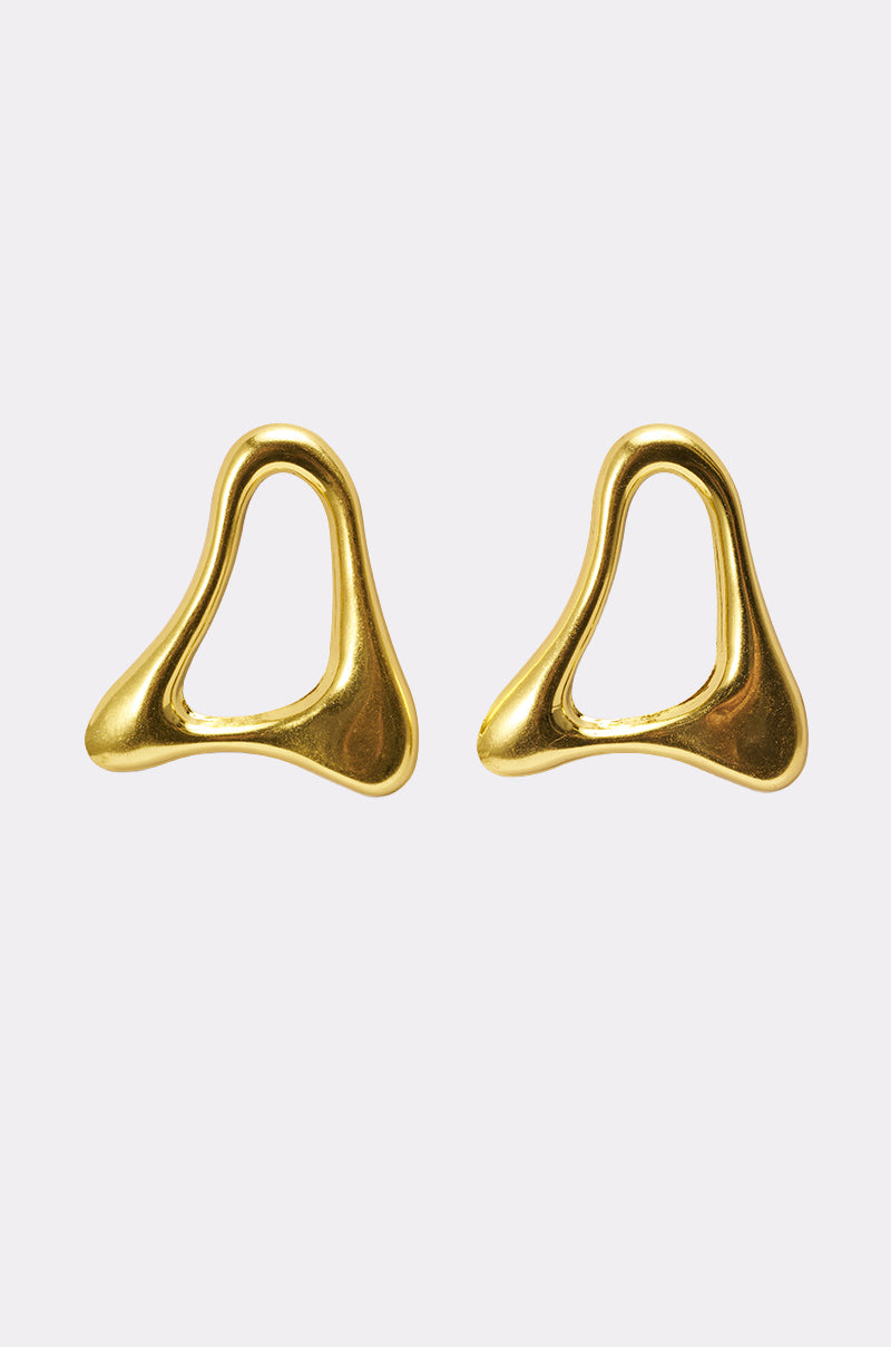The MOD GAL EARRING features sculptural gold statement earrings with smooth, flowing edges and an abstract, irregular shape, displayed on a plain light background. 2