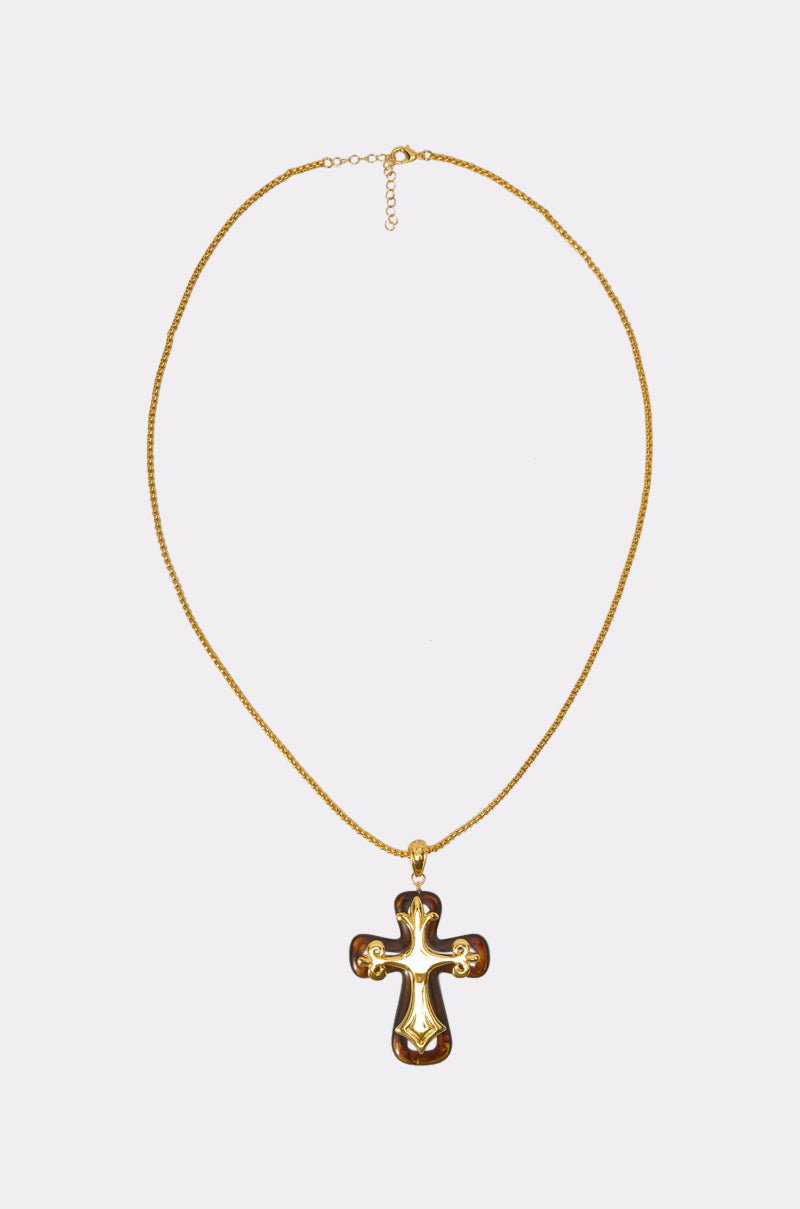 The BEST OF LUCK NECKLACE features a large, shiny gold cross pendant that exudes classic gothic jewelry style, photographed on a plain white background. 1
