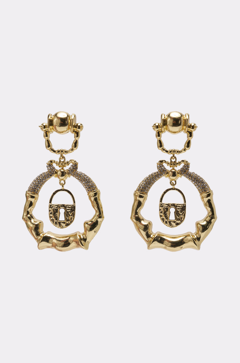 The FLYING OUT EARRING features gold-tone drop earrings with a bamboo-like texture, rhinestone accents, and a hanging lock charm with a central keyhole. Bold and ornate in design, they're finished with a polished shine. 0