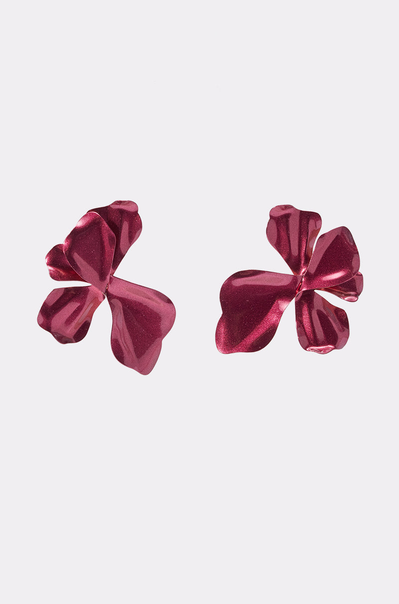 A pair of REDDY EARRING metallic pink floral earrings featuring hammered, petal-like silhouettes, shown on a plain light background.