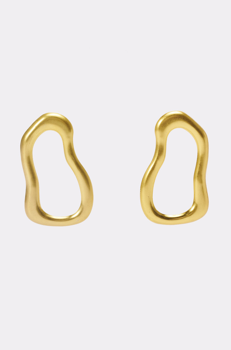 Add a touch of artistry to your vacation or festival look with the WAVEY BABY DANGLE EARRING IN GOLD—these unique earrings feature irregular, organic gold loops with smooth wavy edges, designed as abstract open ovals and beautifully displayed against a plain white background.