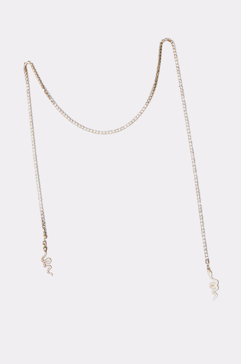 The TAKE ME TO THE FESTIVAL FACE CHAIN is a delicate gold chain necklace with small gold snake pendants at both ends, shown on a plain white background—ideal for adding subtle festival flair to your style. 2