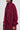 Dressed in a cozy, oversized burgundy sweater dress paired with the PINKY PROMISE SOFT KNIT CARDIGAN, the ensemble's faux mohair texture offers both warmth and style. With short hair and chic earrings, the look is fuzzy yet fashion-forward.