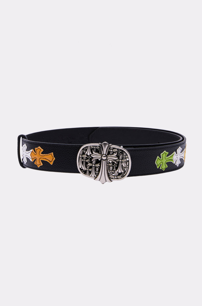 The CROSS ME BELT is a pebbled faux leather belt with a gothic silver buckle and embroidered crosses in white, yellow, and green along the strap, shown against a plain white background. 3
