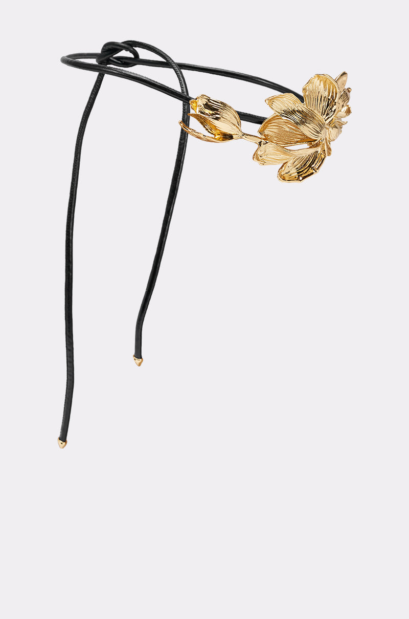 The PETAL POWER METAL DETAIL BELT features a bold gold flower and bud accent on one side, with sleek gold ends, making it a standout accessory. Shown against a plain white background. 3