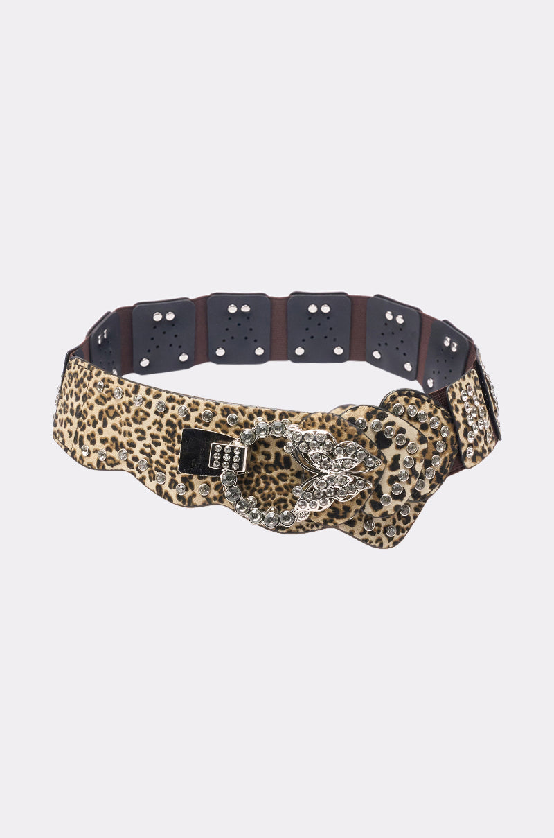 The CHANGE NOTHING BELT is a wide leopard print accessory with a rhinestone snake buckle and black elastic segments with metal eyelets for a bold, stylish look. 1