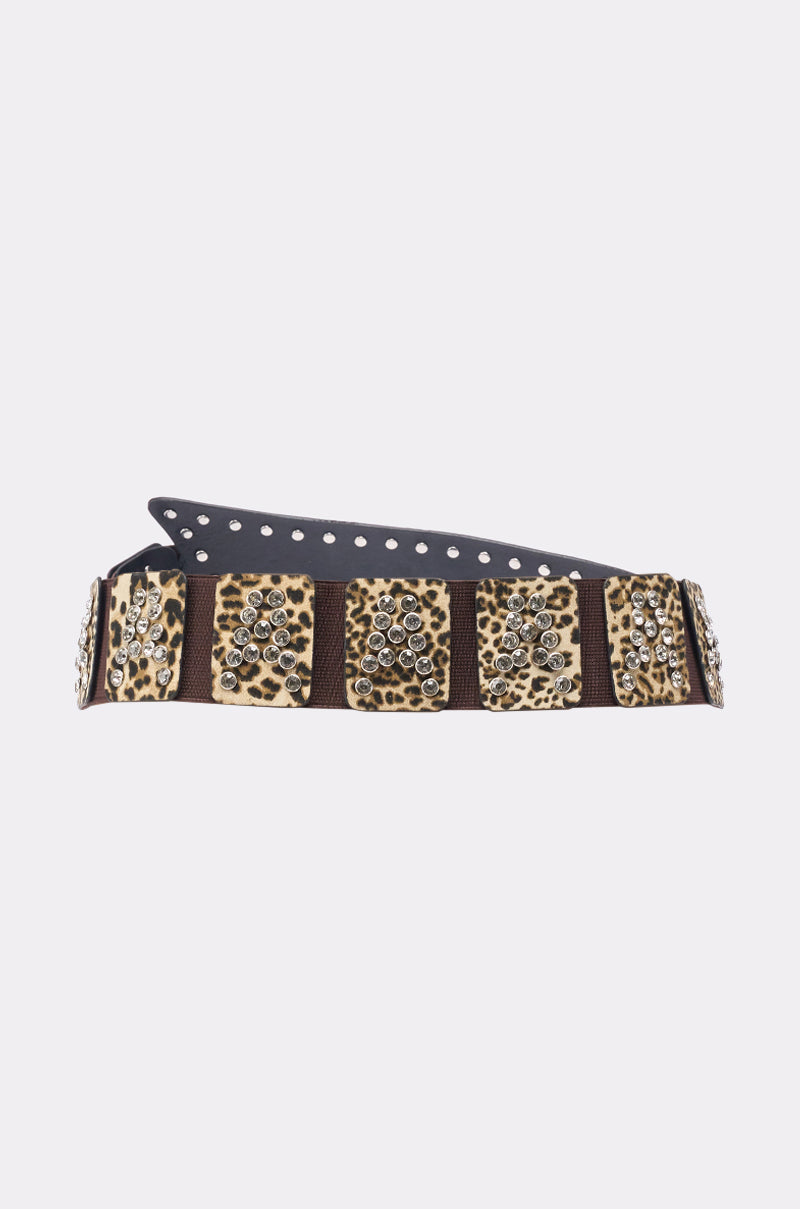 The CHANGE NOTHING BELT is a stretchy leopard print waist belt featuring large square panels and clusters of silver studs, shown on a plain light background. 4