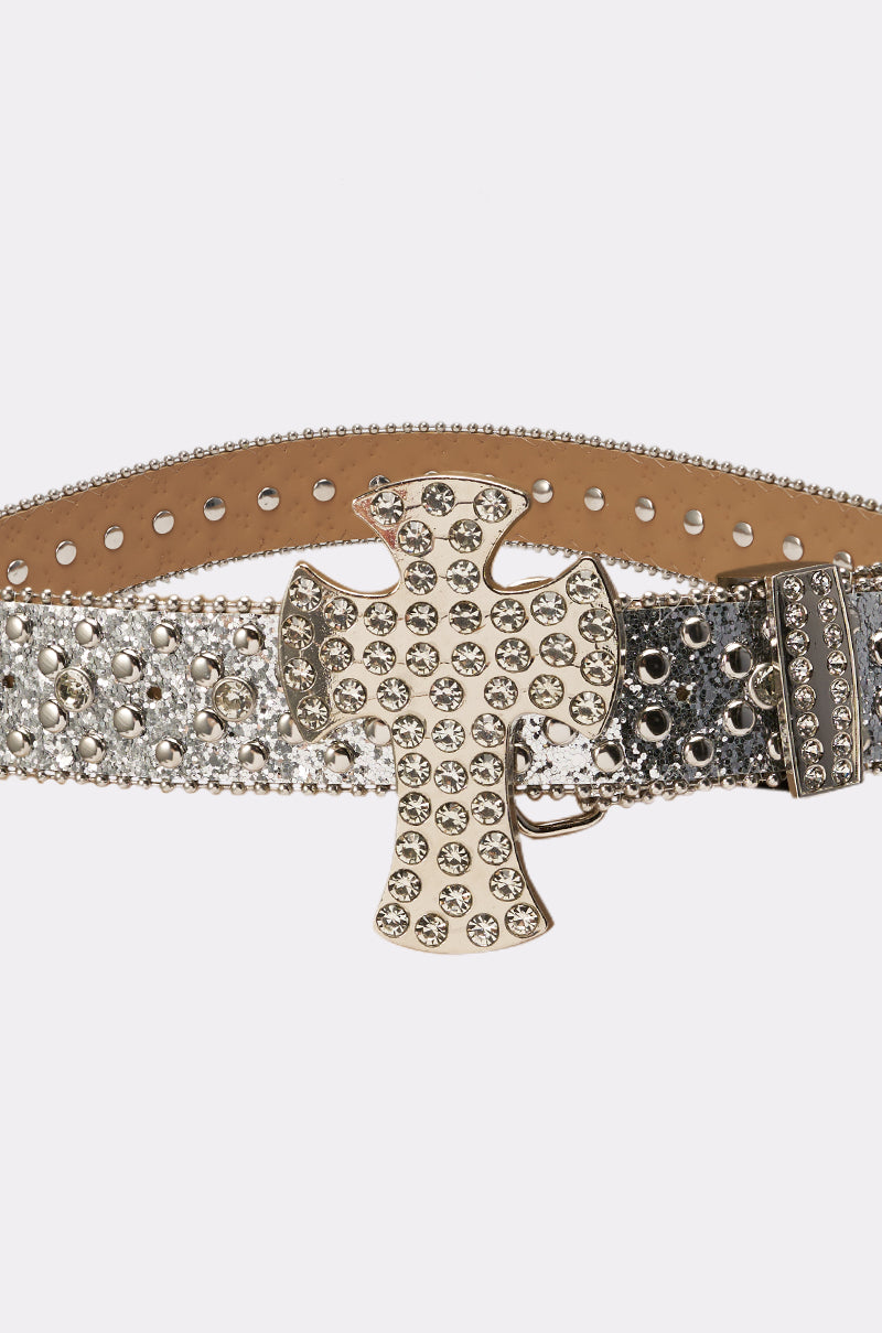 The IM BETTER BELT is a wide, silver rhinestone western belt with an oversized cross buckle and metallic studs on a two-tone textured background—an eye-catching festival accessory. 6