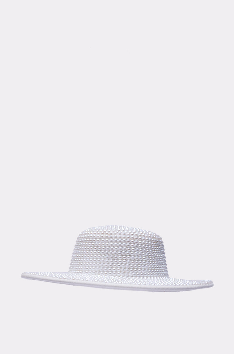 The POLLY PEARL BRIM HAT is a wide-brimmed, white woven straw hat with a flat crown and delicate faux pearl accents along the brim, shown against a plain light gray background. 4