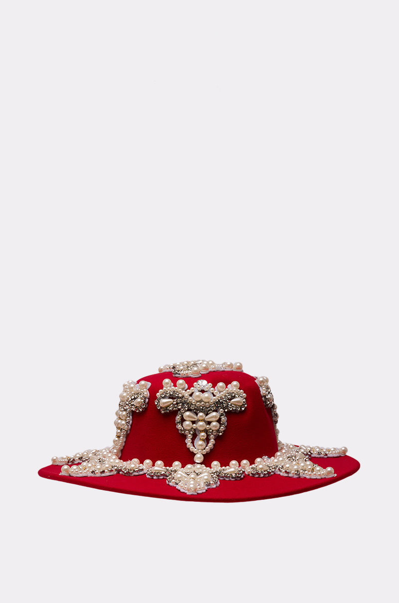 The EDITORS PICK APPLIQUE BRIM HAT features a red pearl brim with intricate clusters of pearls, rhinestone detailing, and jeweled embellishments, showcased against a plain light gray background. 2