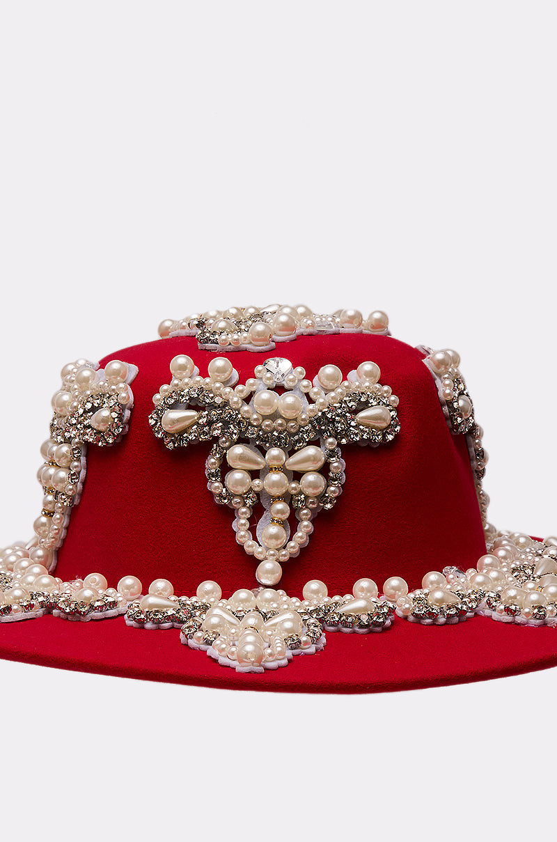 The EDITORS PICK APPLIQUE BRIM HAT is a red hat adorned with intricate beadwork, featuring pearl and silver rhinestones in ornate patterns, including a central floral-inspired motif. 8
