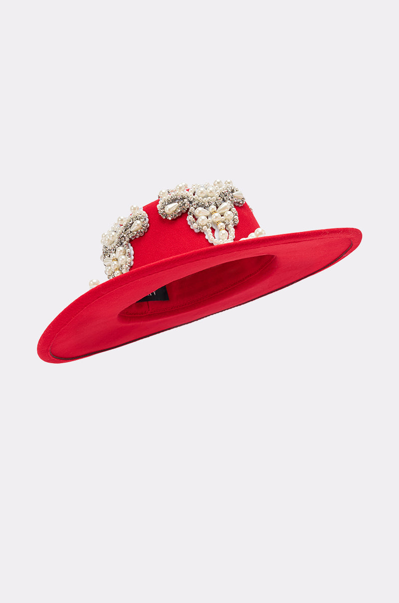 The EDITORS PICK APPLIQUE BRIM HAT features a wide red brim with rhinestone detailing and clusters of pearls and gemstones around the crown, showcased against a plain light background. 4