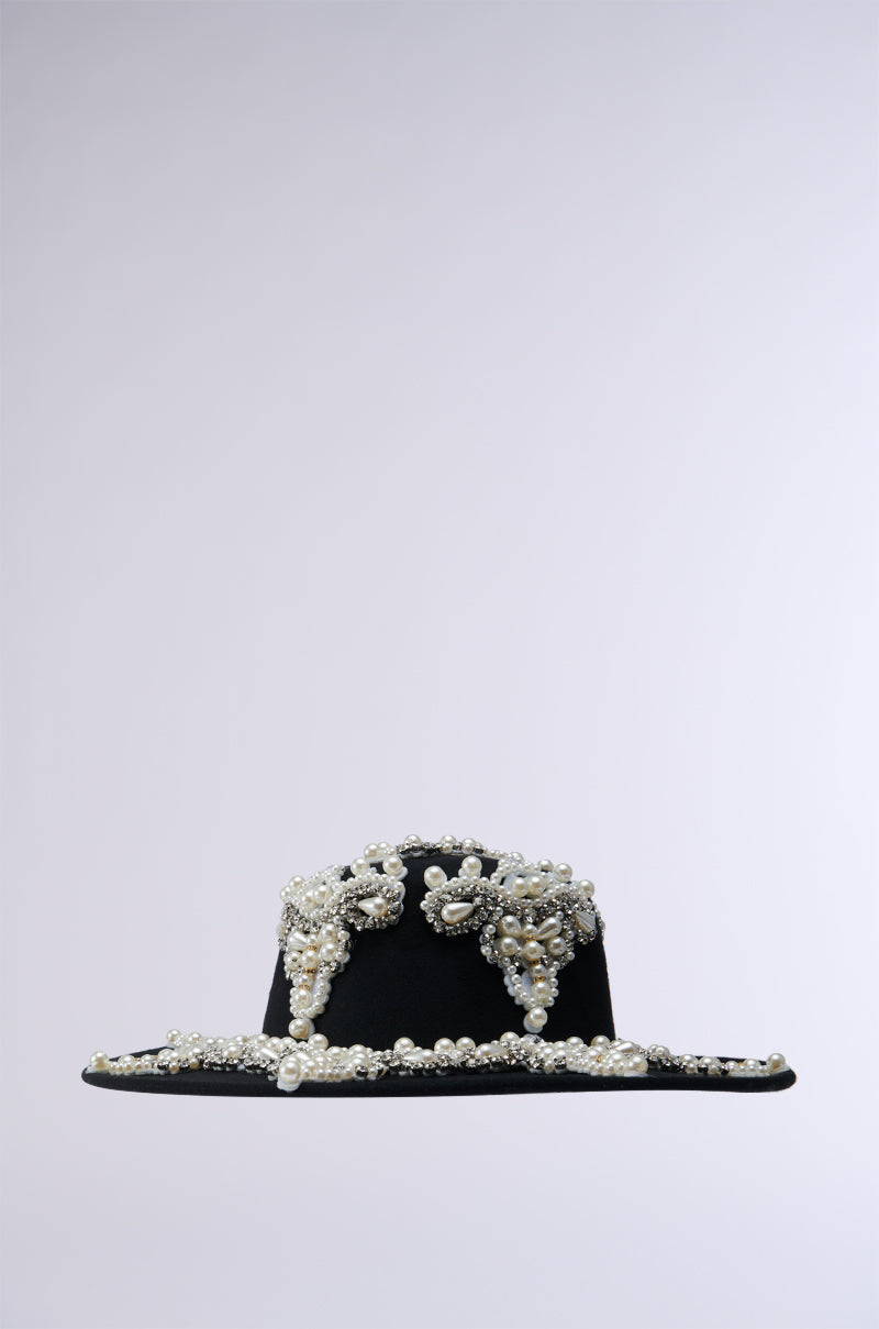 The PEARL PLEASE EMBELLISHED BRIM HAT features intricate beading and rhinestone details with elaborate designs that adorn the crown and part of the wide brim, all set against a plain light grey background. 9