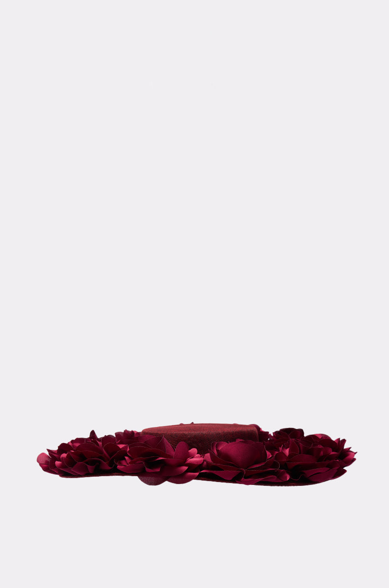The ROSEY CLIP ON HAT features layered maroon fabric flower petals and elegant 3D rose detailing, shown against a plain light gray background. 5