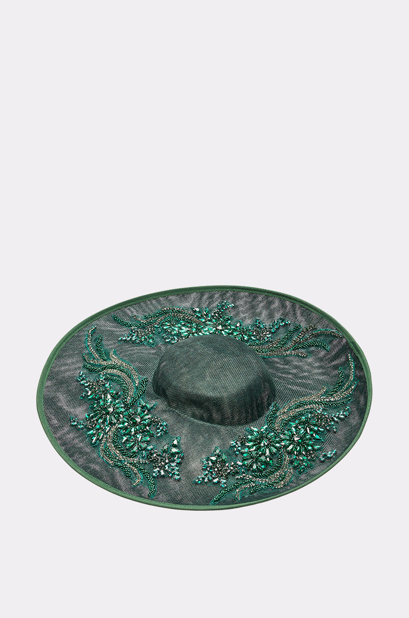 The NO ENVY CLIP ON HAT is an emerald green, wide-brimmed hat adorned with green beaded and sequin floral patterns plus crystal embellishments, shown on a plain white background. 1