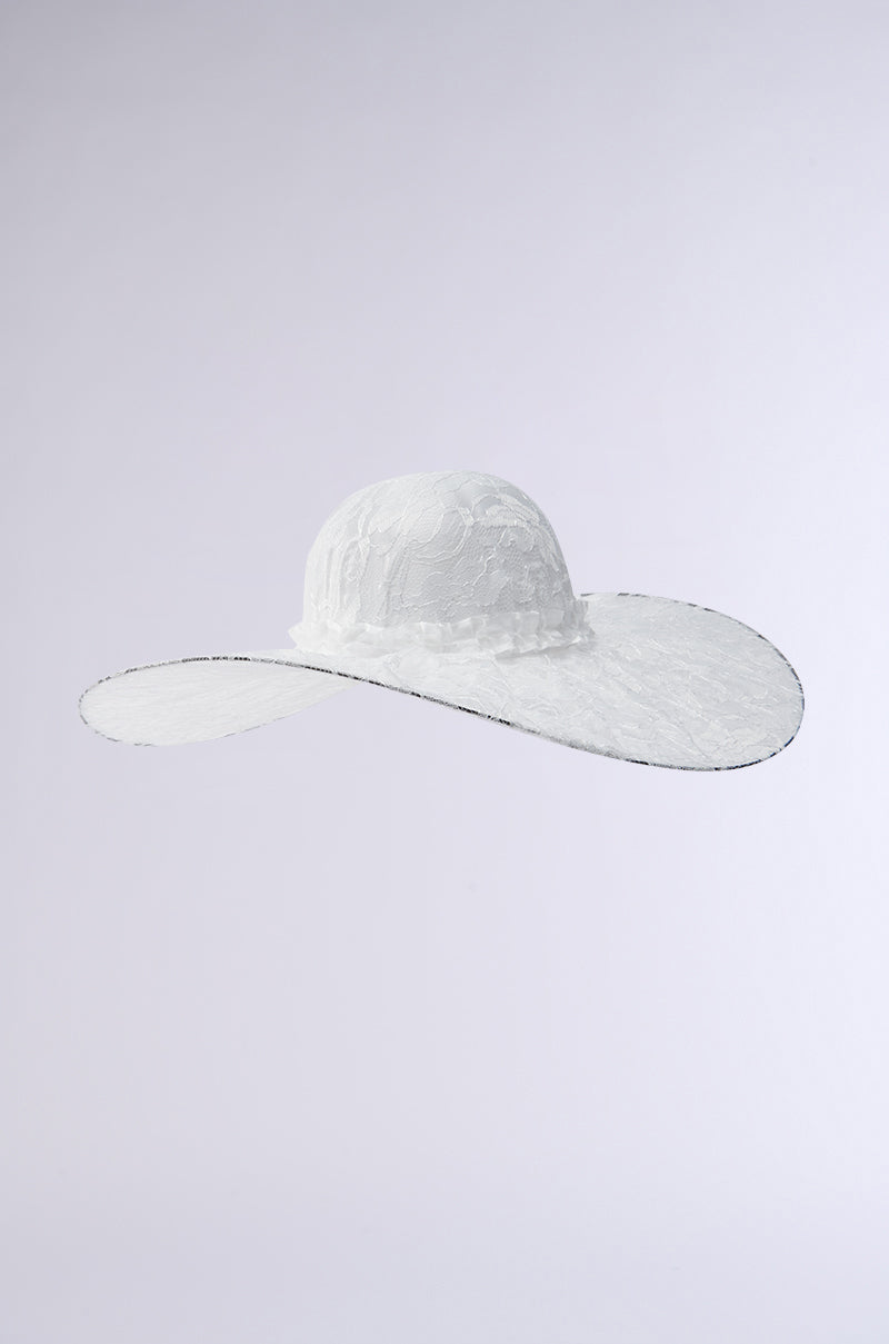 The I AM IT LACE HAT is a large, elegant floral lace sun hat with a wide brim and rounded crown. Its intricate lace texture adds a sophisticated touch against its plain light gray background. 9