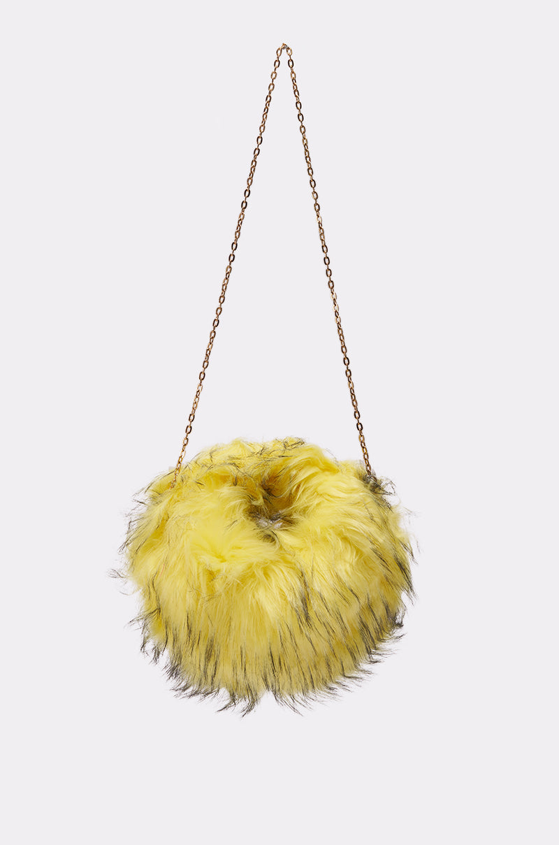 The ELLIE FAUX FUR PURSE is a round, fluffy yellow bag with brown-tipped faux fur and a slim gold chain strap, shown on a plain white background. 0