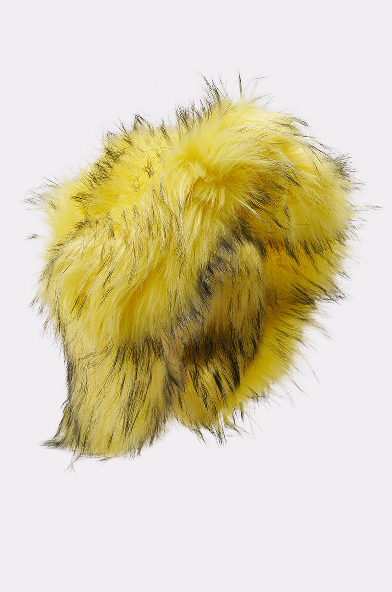 The ELLIE FAUX FUR BUCKET HAT features fluffy, bright yellow faux fur with black streaks, shown on a plain white background. 2