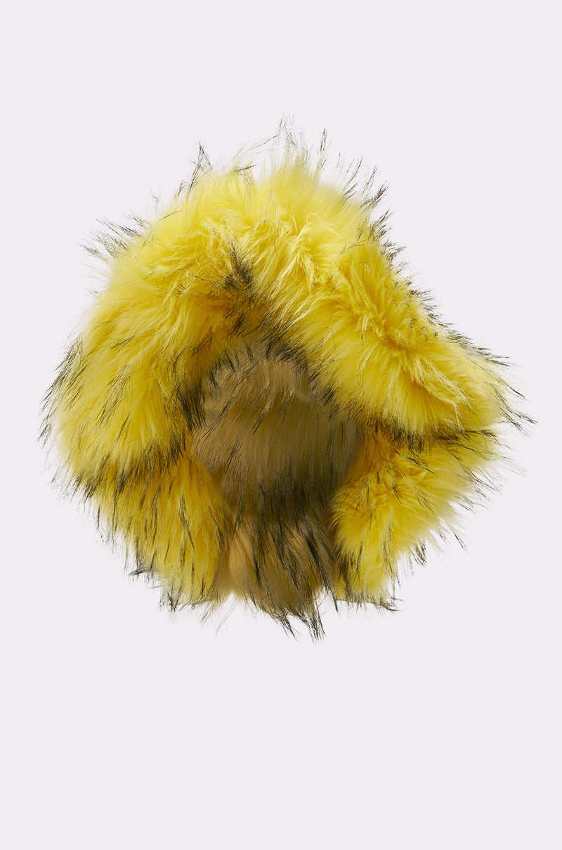 The ELLIE FAUX FUR BUCKET HAT features fluffy yellow faux fur with black-tipped accents, capturing a playful AKIRA Label vibe when viewed from above on a plain white background. 3