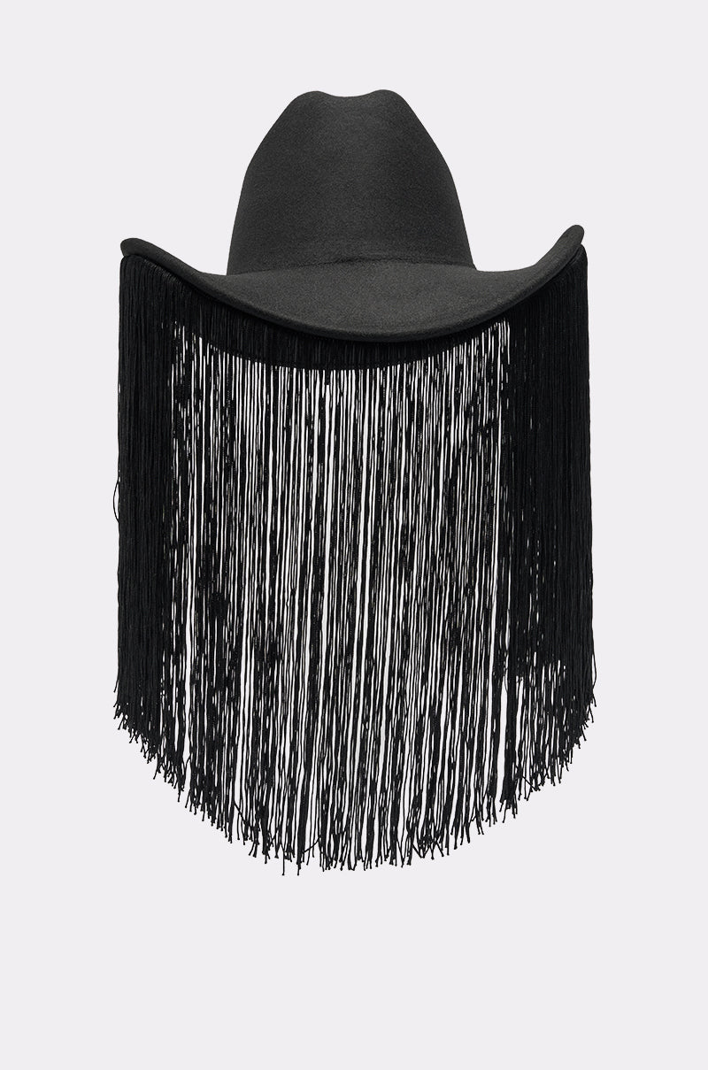 The CALL MY HATERS FRINGE BRIM HAT is a black cowboy hat with long fringe hanging from the brim, covering the front and sides, shown against a plain light gray background. 4