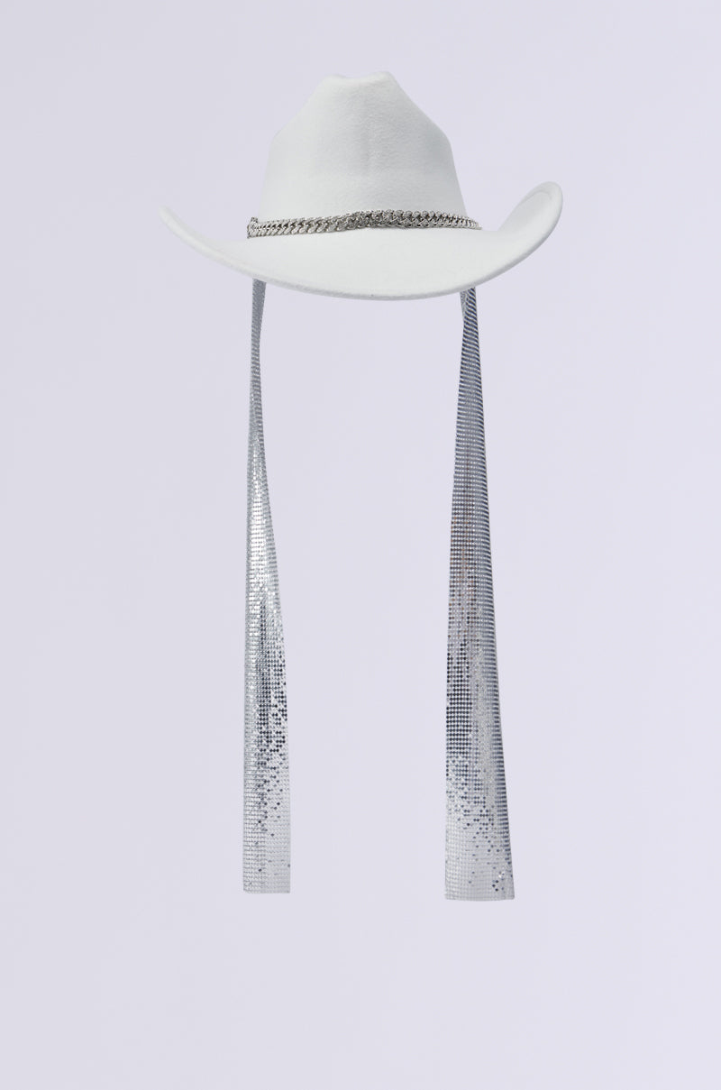 The QUEEN CHAINMAIL COWBOY HAT is a white hat adorned with a silver chain around the crown and features two long, rhinestone-embellished ribbons hanging from the sides, set against a light gray background. 5