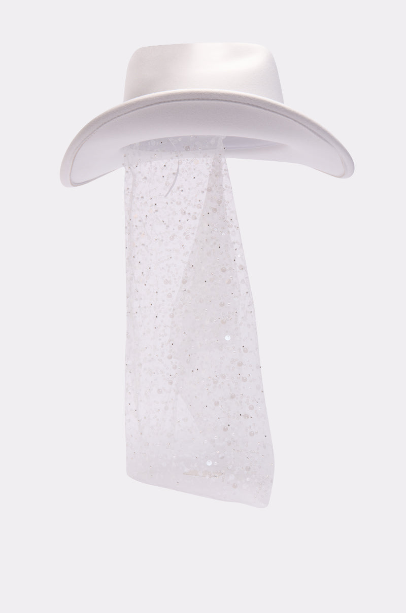 The IM THE QUEEN COWBOY HAT showcases a long, sheer mesh veil with elegant sequin detailing, set against a light gray background. 5