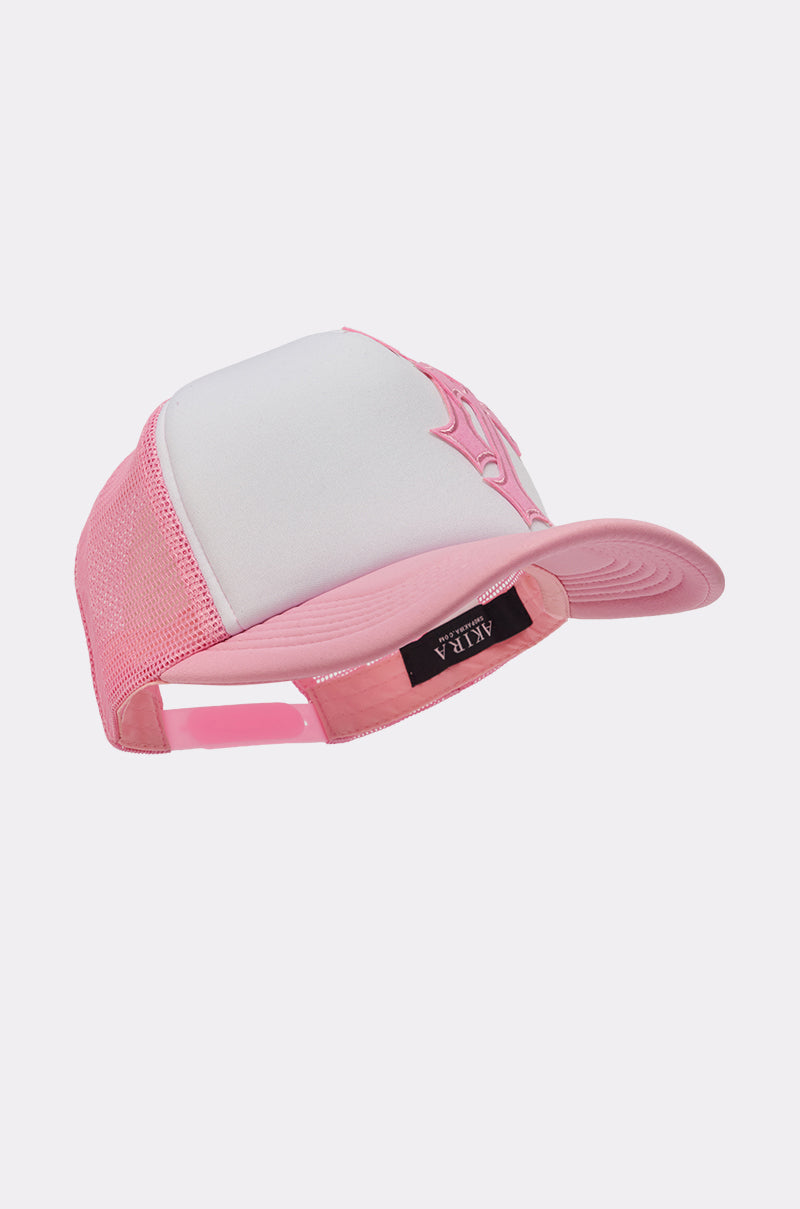 The CROSS ME PATCH HAT is a pink trucker cap with white mesh and an adjustable snapback. It features a black "ALPHA" label on the back, solid panels, and breathable mesh—ideal for street style and any casual outfit. 4