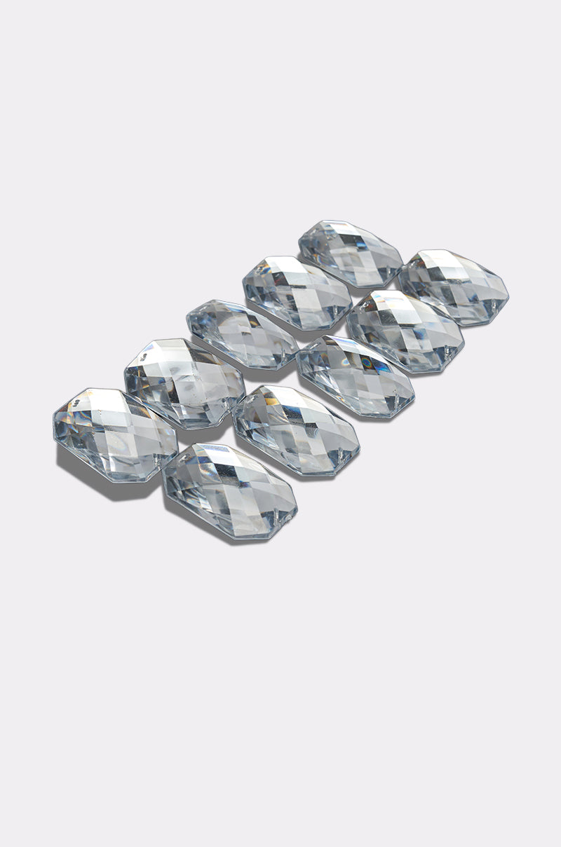 Ten clear, faceted gems from the DIAMONDS DANCING HAIR CLIP SET are arranged in two neat rows on a light gray background. 3
