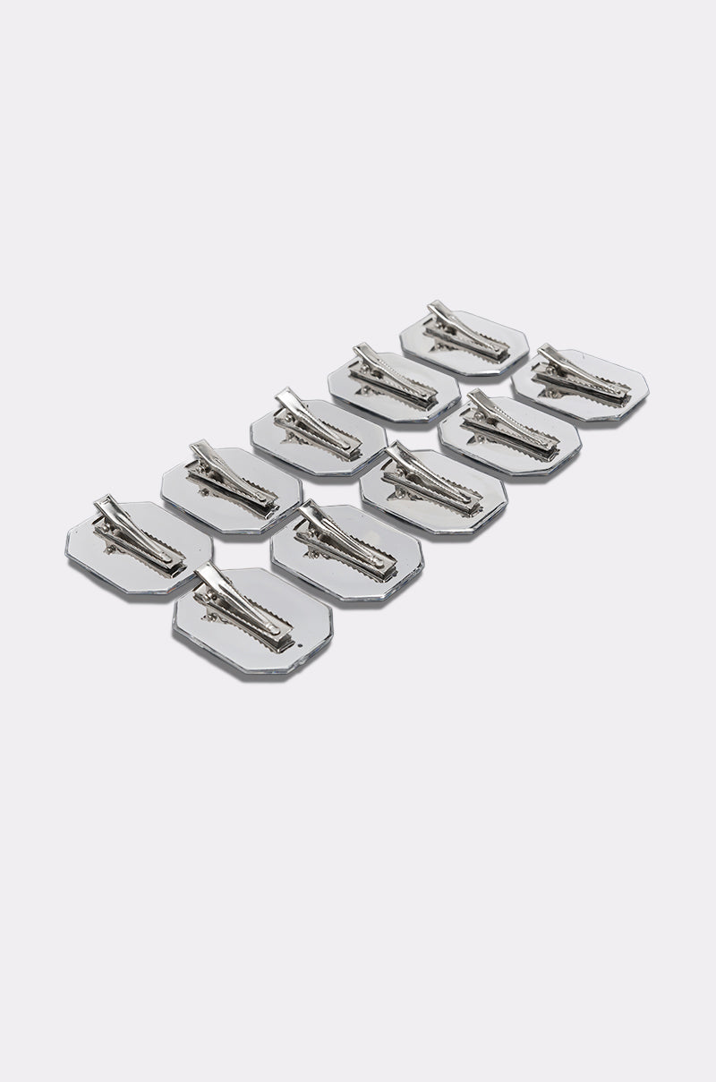 Ten DIAMONDS DANCING HAIR CLIP SETS, featuring hexagonal silver clips with a shimmering barrette-style design, are arranged in neat rows on a light gray background to showcase these elegant hair accessories.