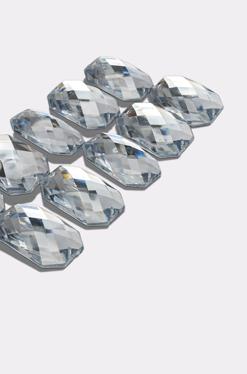 Ten faceted, clear, oval gemstones on the DIAMONDS DANCING HAIR CLIP SET create a sparkling, prism-like shine, beautifully displayed against a light gray background.