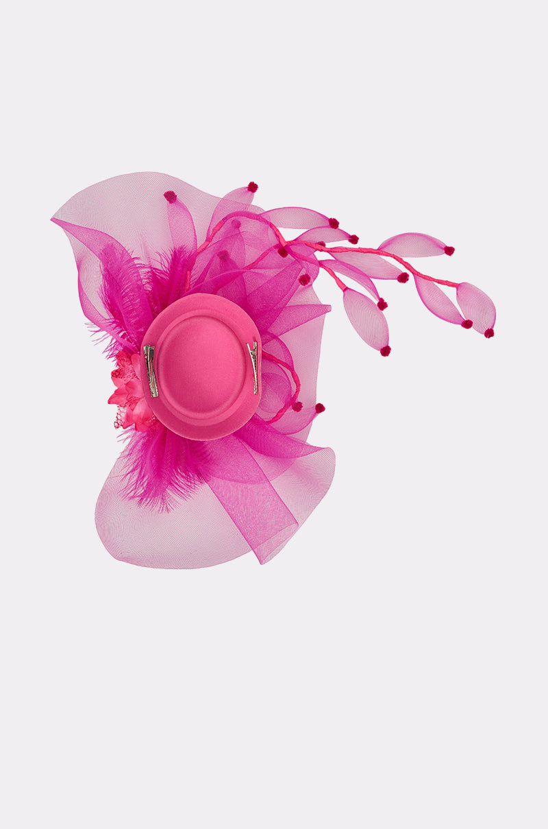 The RIRI HEADPIECE is a vibrant hot pink accessory featuring sheer fabric, feathers, and curved stems with red tips, beautifully photographed on a light background—a bold choice for any festival look. 5