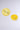Two lemon slice designs rest on a light gray background; one looks realistic, the other stylized—perfect inspiration for the playful LIFE GIVES YOU LEMONS HAIR CLIP SET, a fun and vibrant barrette-style hair accessory.