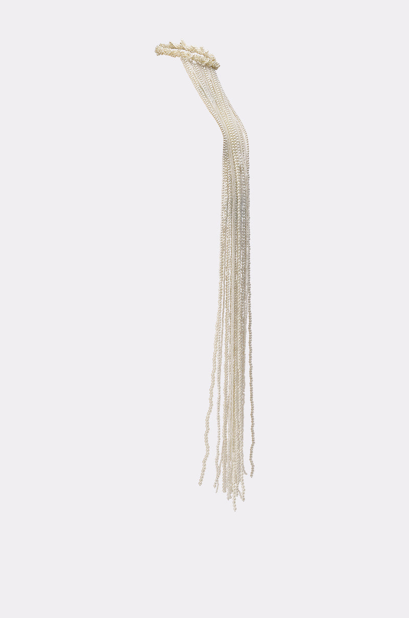 The PURE VIBES PEARL HAIR ACCESSORY features multiple thin, silver strands cascading gracefully, reminiscent of mermaid-core style, and is displayed against a plain white background. 4