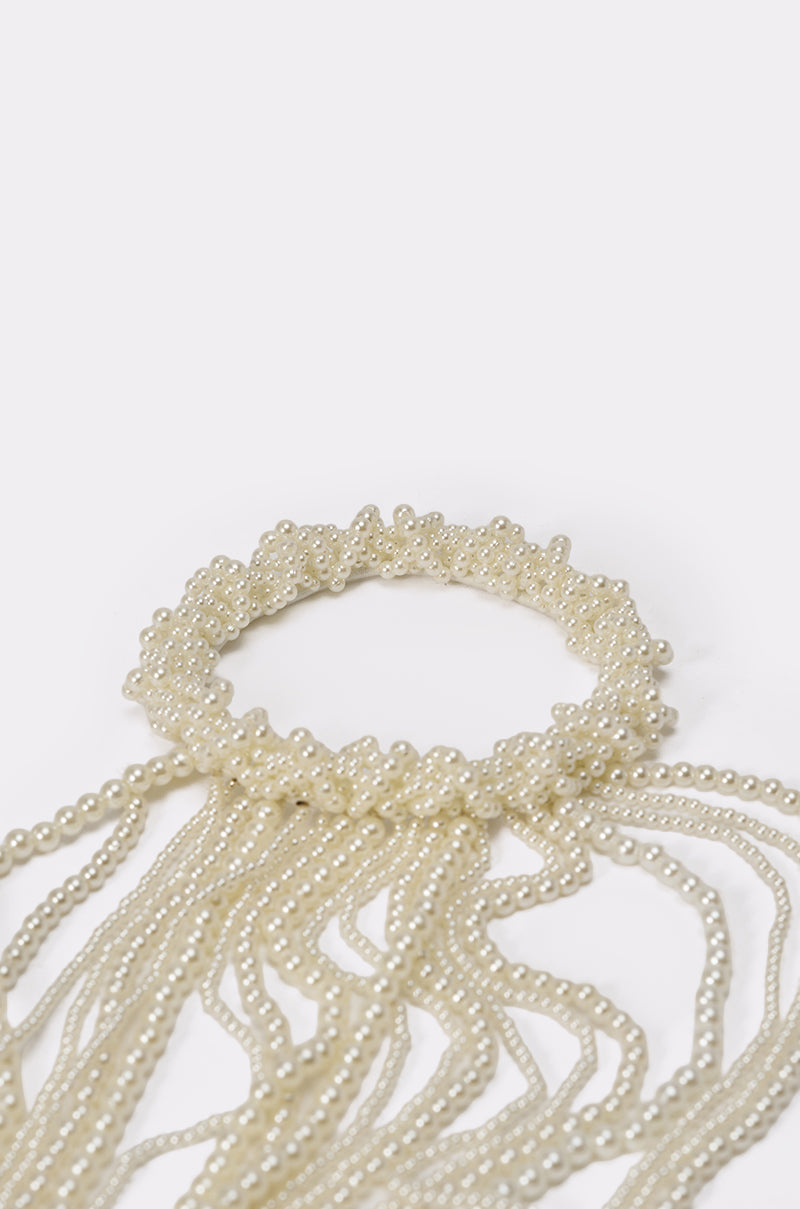 The PURE VIBES PEARL HAIR ACCESSORY is a circular, multi-strand faux pearl bracelet and hair elastic with cascading cream beads—an elegant mermaid-core piece shown against a white background. 6