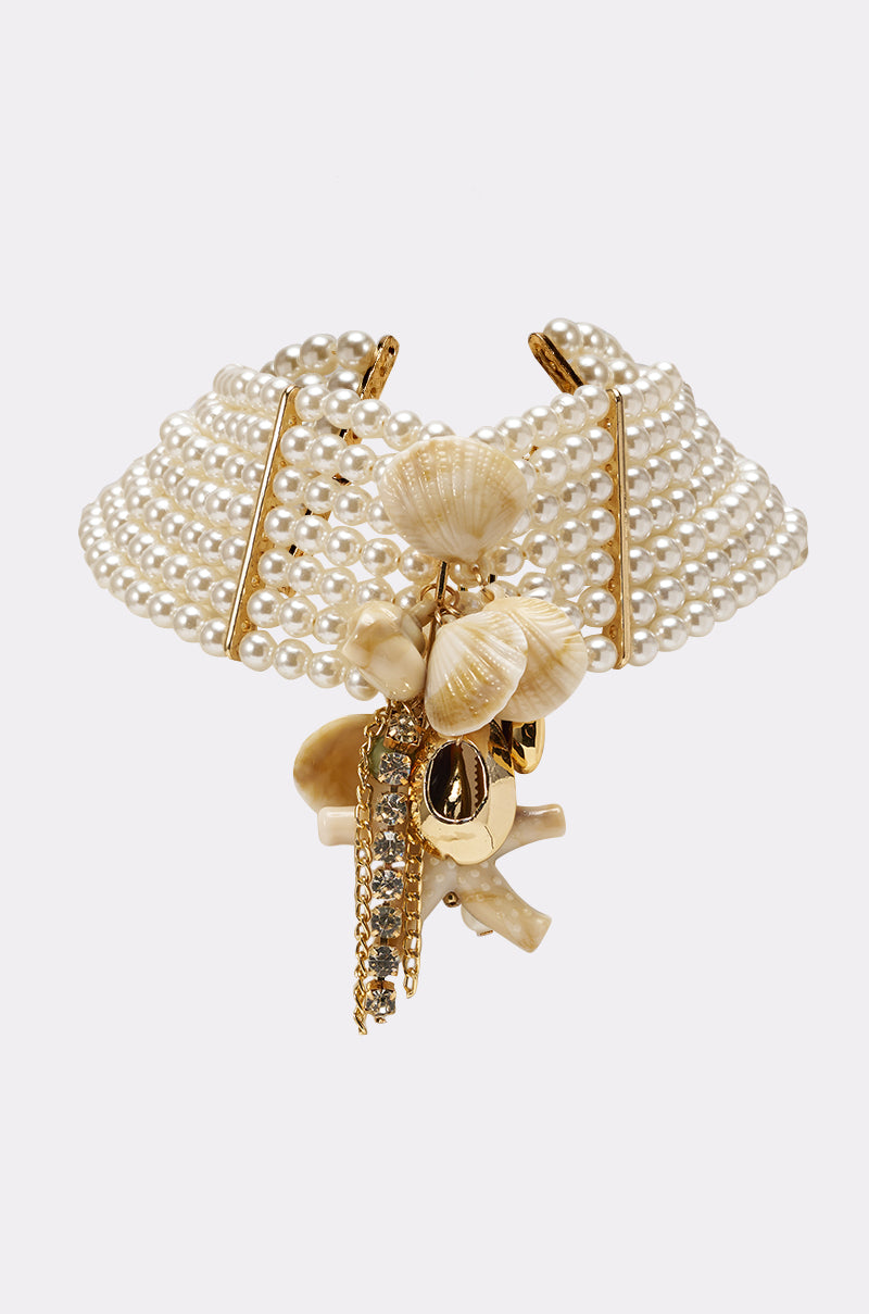 The FEELIN HOT NECKLACE is a pearl choker with multiple strands, gold accents, and sea-themed charms such as seashells, coral, and rhinestones. Photographed on a plain white background. 1