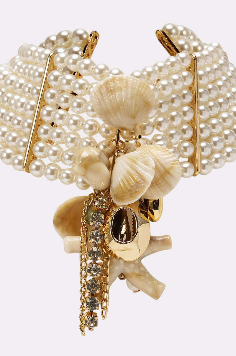 The FEELIN HOT NECKLACE is a statement choker with multiple pearl strands, gold accents, hanging seashells, coral-shaped charms, gold chains, and a central rhinestone row—perfect for any occasion. 2
