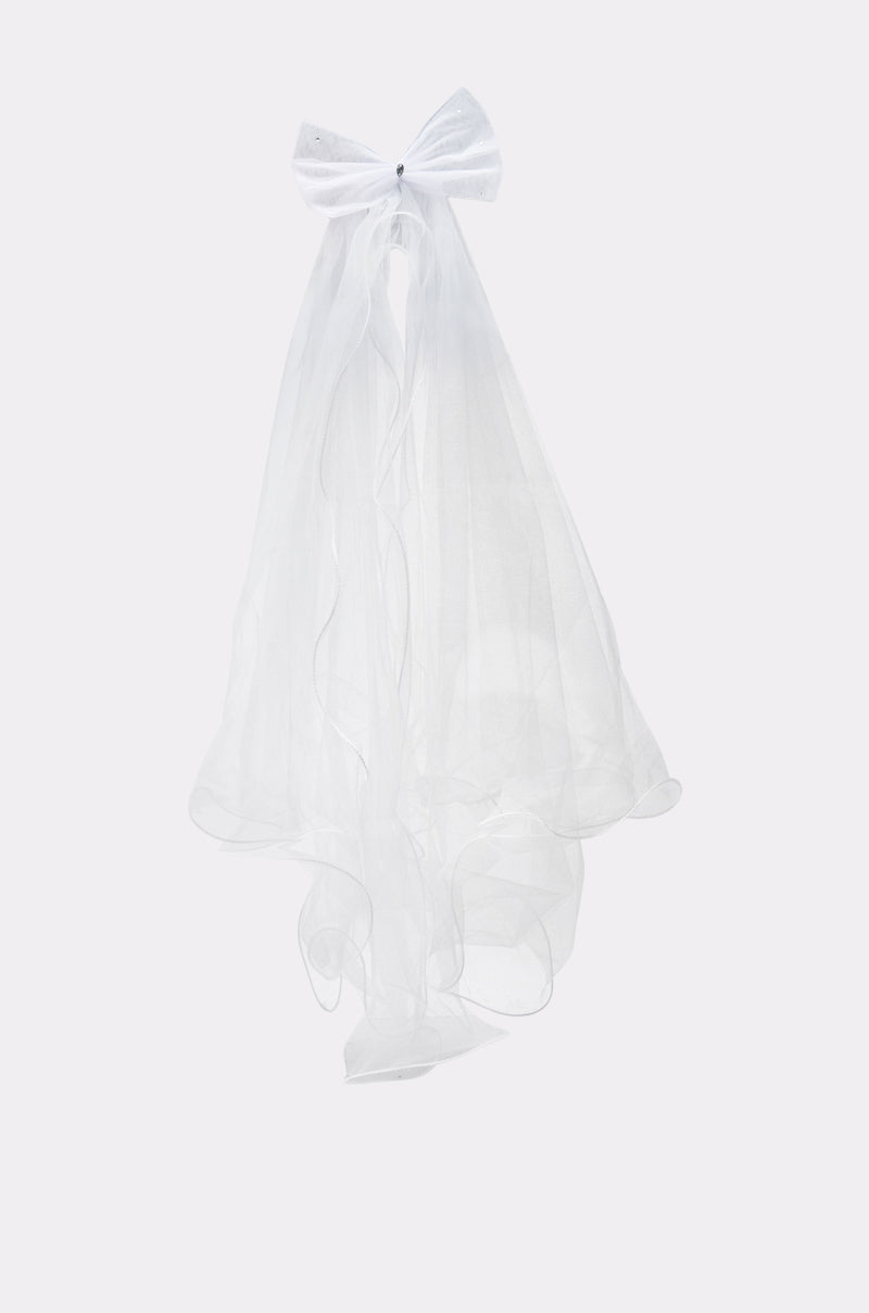 The TO THE EXTREME HAIR BOW is a sheer white oversized bow with long, translucent ribbon tails, displayed on a plain light gray background.
