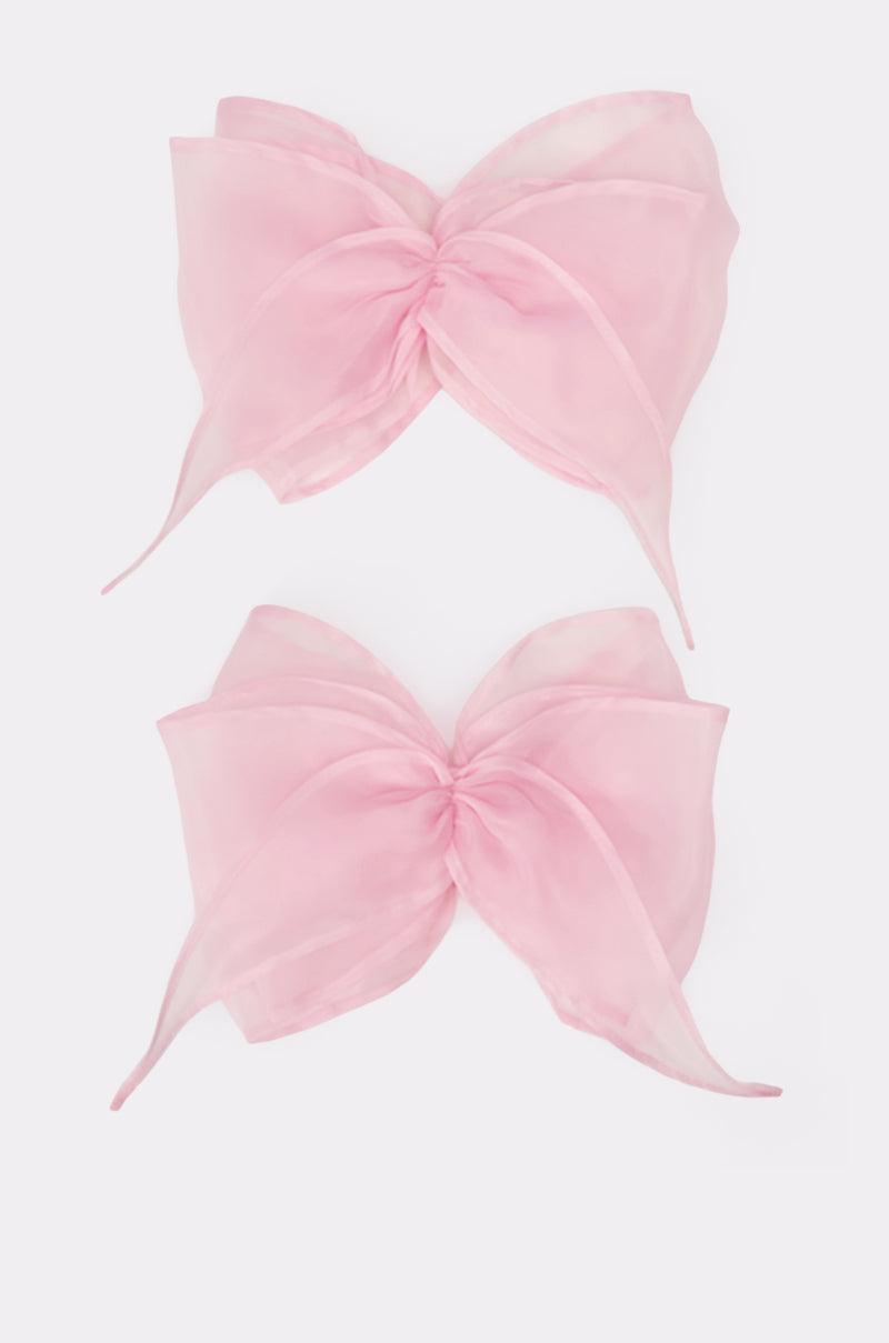 Two large, sheer blush pink "TIE IT WITH A BOW SLEEVES" accessory bows, crafted from lightweight fabric, are displayed on a plain white background, stacked vertically. 1