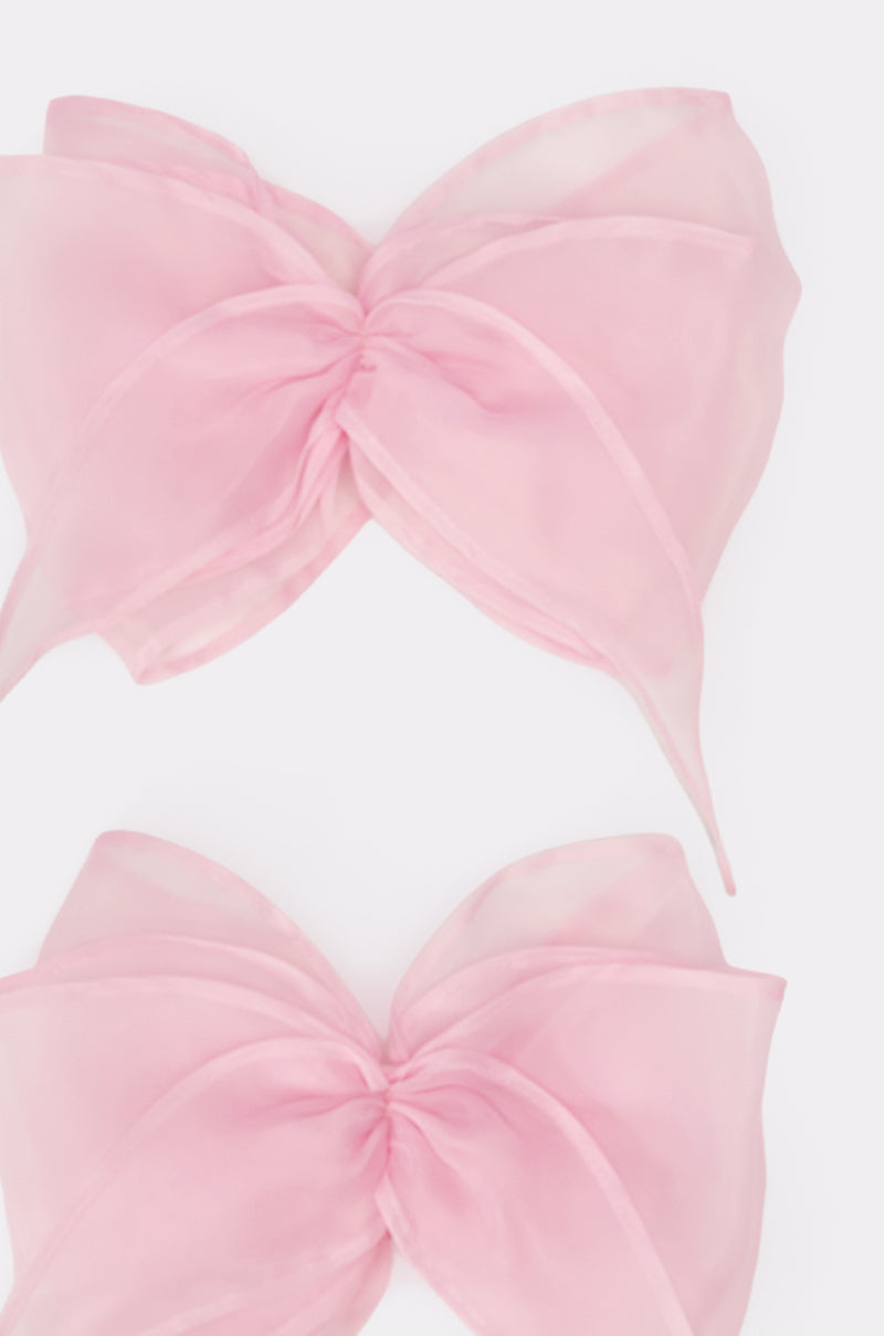 TIE IT WITH A BOW SLEEVES features two large, sheer blush pink organza bows with soft, flowing loops and tails, shown on a plain white background—an ideal light, airy bridal accessory. 2