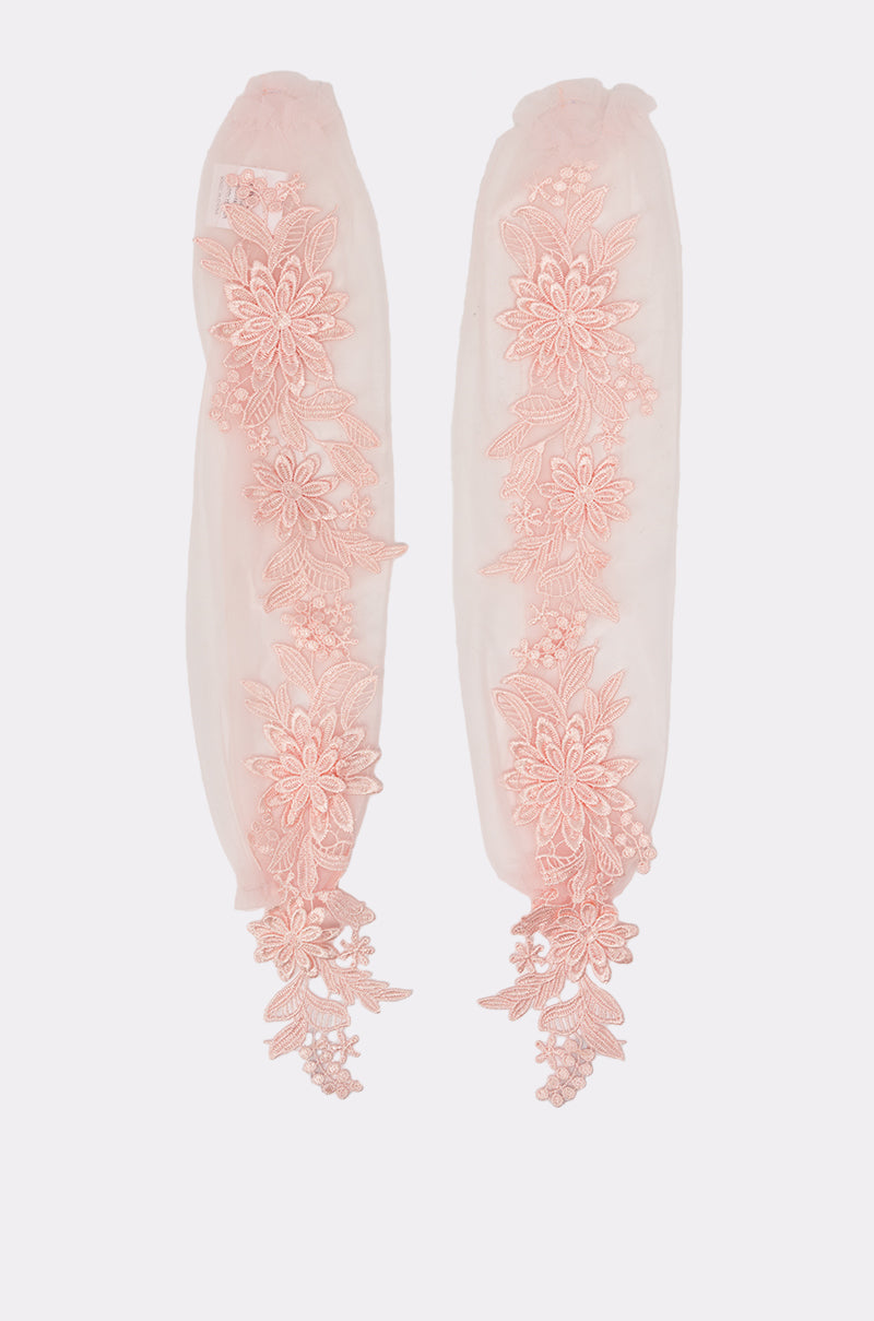 The ULTIMATE APPLIQUE FINGERLESS GLOVES feature sheer pale pink tulle and vertical floral lace appliqué, capturing the delicate charm of bridal accessories against a plain background. 1