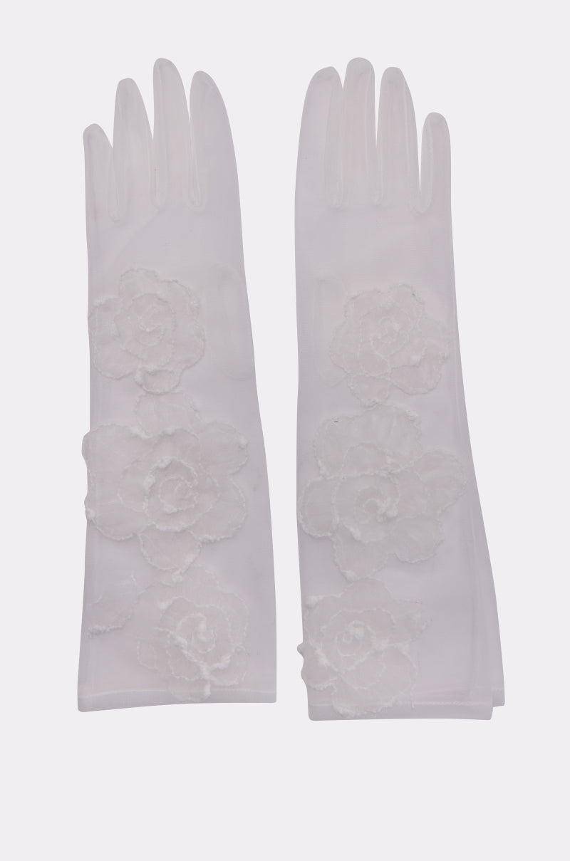 The FLORA MESH GLOVES IN WHITE are sheer, floral gloves with large embroidered appliqués, shown against a simple light background. 2